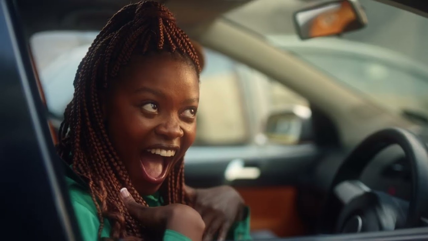 Woman with dreadlocks in driver's seat of car